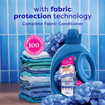 Suavitel Complete Care bottle beside folded blue towels and hydrangea flowers with 'fabric protection technology' text