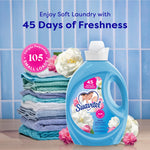 Suavitel Field Flowers fabric conditioner bottle staged next to folded towels and floral accents with freshness text