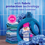 Suavitel Complete Care bottle in front of folded towels and hydrangea flowers with a pink badge reading ‘158 small loads’