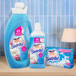 Product group shot of Suavitel Field Flowers family: large bottle, travel-size bottle and box of sheets on a tiled background