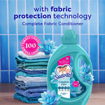 Suavitel Complete Care Waterfall Mist bottle beside stacked blue towels and floral accents with promotional text background.