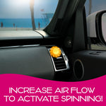 Yellow sun-shaped air freshener clipped into car vent shown on passenger-side dash