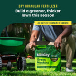 Lifestyle photo of person kneeling on lawn next to a spreader, holding a Sunday Green Machine bag displayed on grass