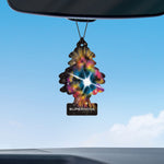 Little Trees Supernova tree-shaped air freshener hanging from a rearview mirror against a blue sky with clouds, showing the colorful galaxy design.