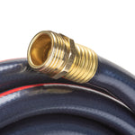 Close-up of a male threaded brass hose fitting resting on coiled dark hose with a red accent stripe