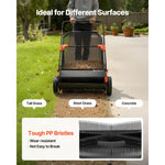 Front view of a lawn sweeper moving from grass to concrete with labels for different surfaces and inset close-up of tough PP bristles.