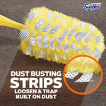 Yellow Swiffer duster head on a wood surface with inset magnified view of dotted dust-busting strips and explanatory text.