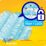 Close-up of blue Swiffer duster fibers with magnified inset showing debris and a 'Trap + Lock' icon on a yellow background.