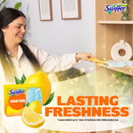 Lifestyle scene of person using Swiffer Duster with lemon-scent packaging and lemon graphic in foreground