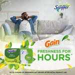 Lifestyle promotional image featuring Swiffer Wet Cloths with Gain logo and freshness-for-hours message over a living room scene