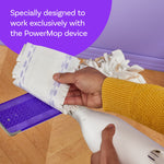 Hand attaching or removing a Swiffer Power Mop wood pad from the mop head, showing backing and textured fringes