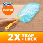 Hand holding a yellow Swiffer handle with a blue duster head cleaning a scratched wood surface, Swiffer logo present.