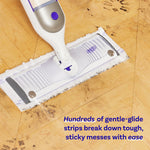 Swiffer Power Mop head with white cleaning pad on a textured wood floor removing dark grime, product text overlay at bottom