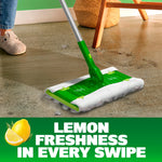 Swiffer mop head fitted with a Hair Magnet cloth cleaning a floor near furniture, emphasizing lemon freshness text below