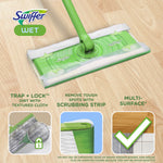 Swiffer mop head with a wet cloth attached shown on a wood floor with icons highlighting trap-and-lock and scrubbing strip.