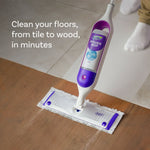 Swiffer Power Mop in use on a floor transitioning from tile to wood, showing the mop head cleaning the wood surface.
