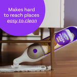 Swiffer Power Mop angled under a low piece of furniture cleaning a wood floor, showing the device and attached wood pad