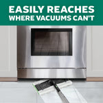 Mop head sliding under a stainless steel appliance with text about reaching where vacuums can't