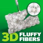 Close-up of a Swiffer refill cloth loaded with hair and dust with a magnified inset showing trapped debris