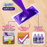 Top-down view of a purple WetJet mop head on a wood floor with callouts highlighting scrubbing strip and floor compatibility