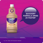 Bottle of Swiffer WetJet Wood floor solution on purple tiled background with callout reading “QuickDry formula dries 2X faster”