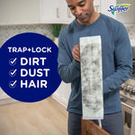 Person holding a Swiffer XL dry cloth on a mop head showing trapped dirt with large text listing ‘Trap + Lock’ benefits
