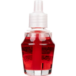 Tall clear fragrance oil refill bottle with bright red liquid and ribbed white plastic cap, isolated on white