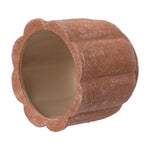 Side-angled view of a terracotta scalloped ceramic planter lying on its side, showing the unglazed interior.