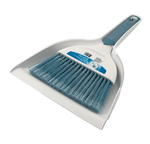 Close three-quarter view of a white dustpan holding a short-handled brush with blue bristles and a blue handle insert
