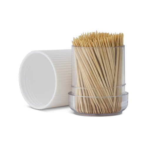 Clear plastic dispenser filled with natural bamboo toothpicks and a white ribbed cap resting beside it