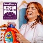 Smiling woman holding a Tide Ultra Sport bottle next to a BrandSpark Most Trusted badge
