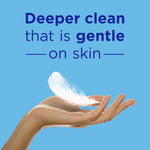 Hand holding a white feather against a blue background with copy stating ‘Deeper clean that is gentle on skin’