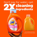 Hand holding an orange Tide + Downy detergent bottle against an orange background with bold promotional copy