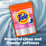 Tide + Downy pouch displayed on textured blue fabric background with tagline about powerful clean and Downy softness