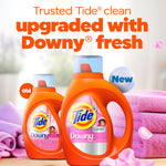 Promotional scene with two orange Tide + Downy bottles on folded towels and headline about Downy freshness