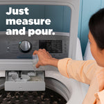 Hand pouring liquid detergent into a washing machine dispenser with overlay text ‘Just measure and pour’