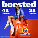 Lifestyle ad showing a woman seated over an orange block with a Tide Spring Meadow bottle and text claiming boosted cleaner and fresher