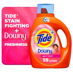 Front-facing Tide Plus Downy April Fresh orange detergent bottle with pink label and promotional pink background