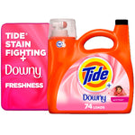 Close-up of an orange Tide bottle labeled with Downy branding beside a pink panel reading "Tide stain fighting + Downy freshness".