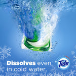 Green-and-blue detergent pac plunging into water with splashes and snowflake accents plus text "Dissolves even in cold water."