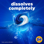 Tide laundry pod dissolving in swirling blue water with bold text 'dissolves completely' on a deep blue background