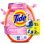 Close-up of a Tide Power PODS Downy pink oval pack with logo, pod image and floral petals floating around.