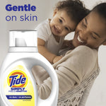 Lifestyle image with a smiling parent and baby and a Tide Simply Free & Sensitive bottle in foreground