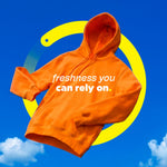 Orange hoodie floating against a blue sky graphic with yellow ring and the text 'freshness you can rely on'