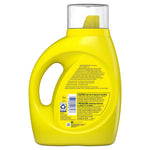 Rear view of a yellow Tide Simply detergent bottle showing warning panel, ingredients text, and clear measuring cap
