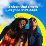 Two smiling people in sunglasses under a blue sky with copy 'a clean that smells as good as it looks' promotional graphic