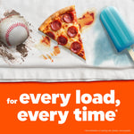 Close-up of a stained towel showing baseball dirt, pizza sauce, and a popsicle stain above text about every load