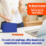 Lifestyle scene showing a spilled drink stain on a white shirt, a small bag, laptop, and a Tide To Go mini pen on a table