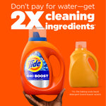 Tide Ultra Oxi Boost bottle held above an orange background with text claiming '2X cleaning ingredients' and a generic yellow bottle