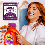 Smiling person holding a Tide Ultra Febreze bottle with a BrandSpark Most Trusted badge in the corner